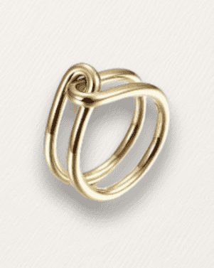 Gold ring with a unique design on a light gray background