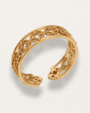 Gold filigree bracelet on a light gray background