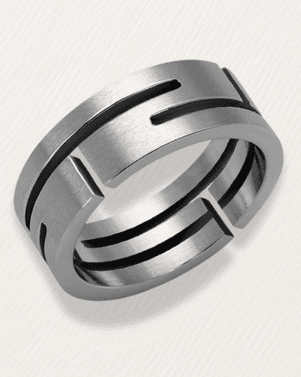 Silver ring with black grooves on a light gray background