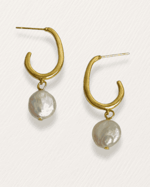 Gold hoop earrings with pearl drops on a white background