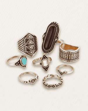 Set of various silver rings with different designs on a white background