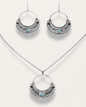 Silver necklace and earrings with turquoise stones on a white background