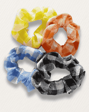 Four colorful scrunchies on a white background