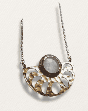 Necklace with a circular pendant on a light gray background