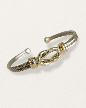 Gold and silver bracelet on a light gray background