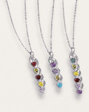 Three silver necklaces with colorful gemstones on a light gray background