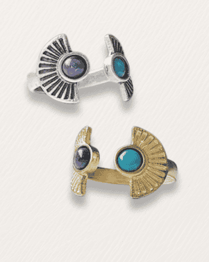 Two bird-shaped cufflinks, one silver and one gold, with gemstones on a white background.