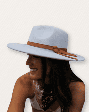 Woman wearing a light blue hat with a brown band on a white background