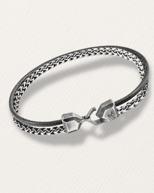Silver bracelet with a clasp on a light gray background