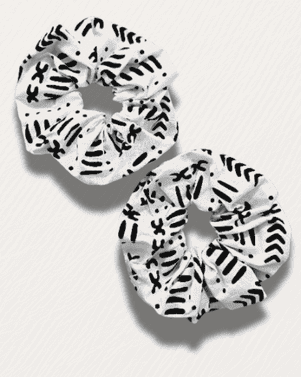 Two black and white patterned scrunchies on a light gray background