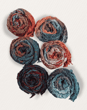 Set of six rolled-up fabric swatches in red, blue, and black on a white background