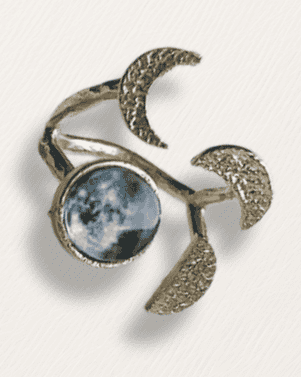 Brooch with moon design on a light gray background