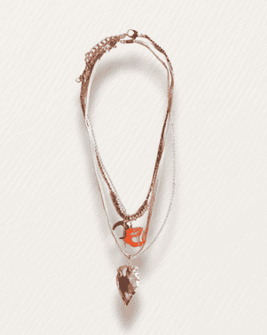 Necklace with multiple strands and a pendant on a light gray background
