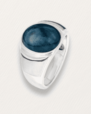Silver ring with a blue stone on a light gray background