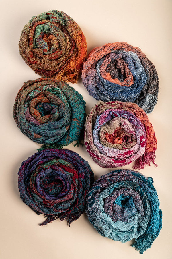 Colorful yarn rolls arranged on a beige background