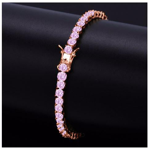 Rose gold bracelet with pink gemstones on a black background