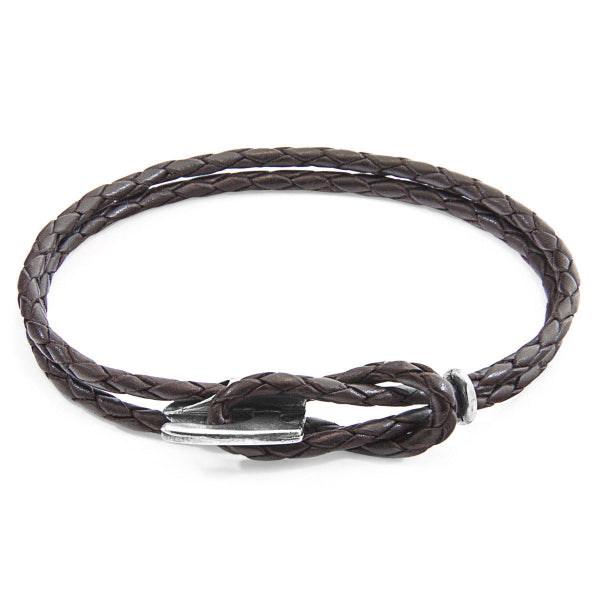 Brown braided leather bracelet with a silver clasp on a white background