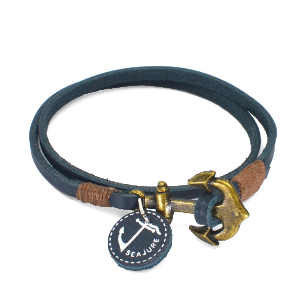 Navy blue leather bracelet with gold anchor charm and Seajure tag on a white background