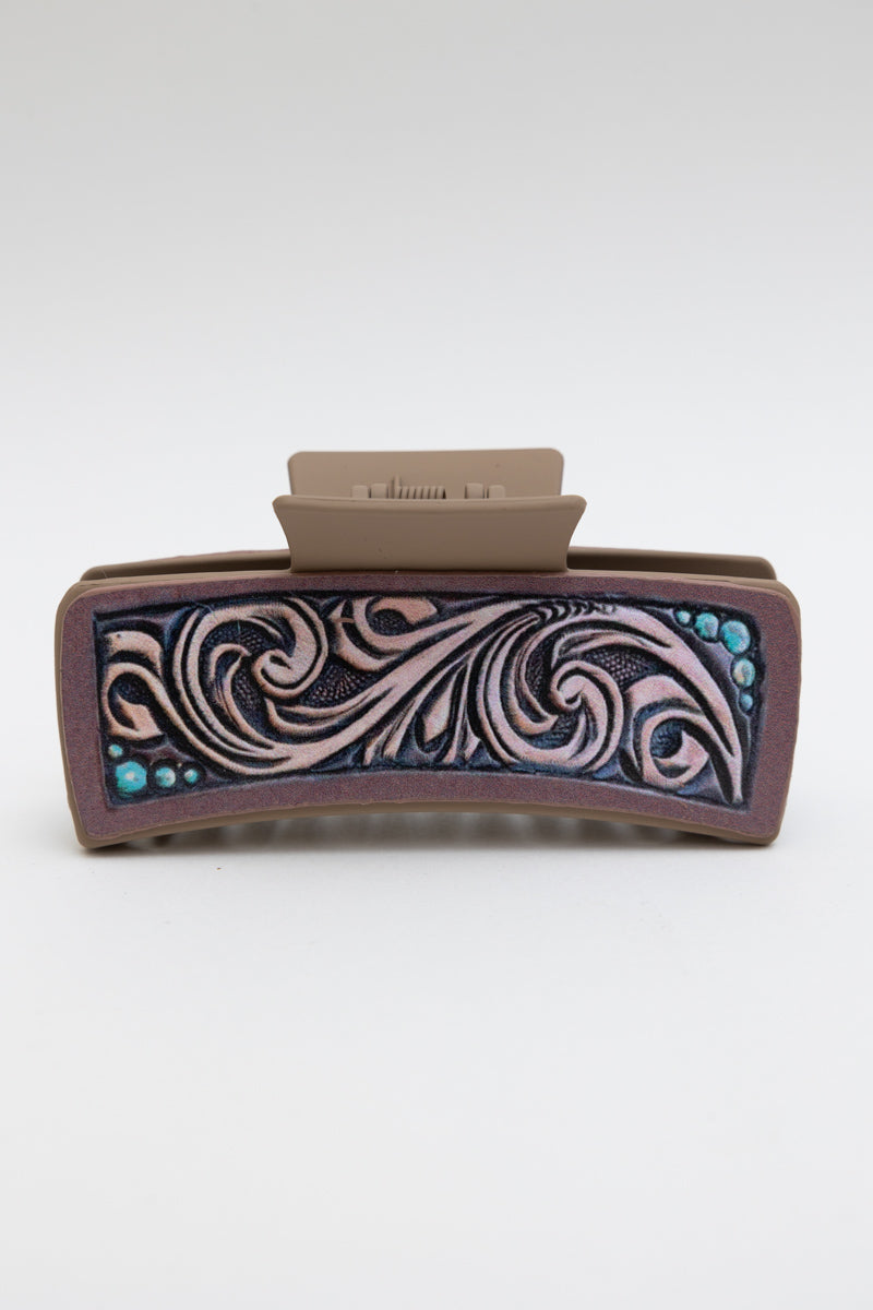 Decorative hair clip with intricate patterns on a white background