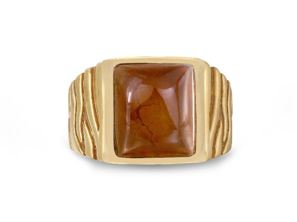 Gold ring with a rectangular stone on a white background