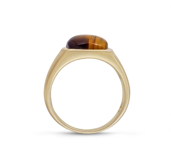 Gold ring with a tiger's eye stone on a white background