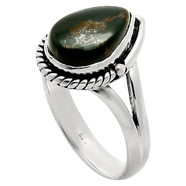 Silver ring with a large green stone on a white background