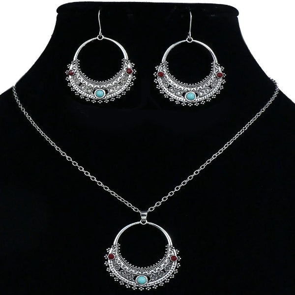 Jewelry set with hoop earrings and necklace on a black background