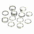 Set of silver rings with various designs on a white background