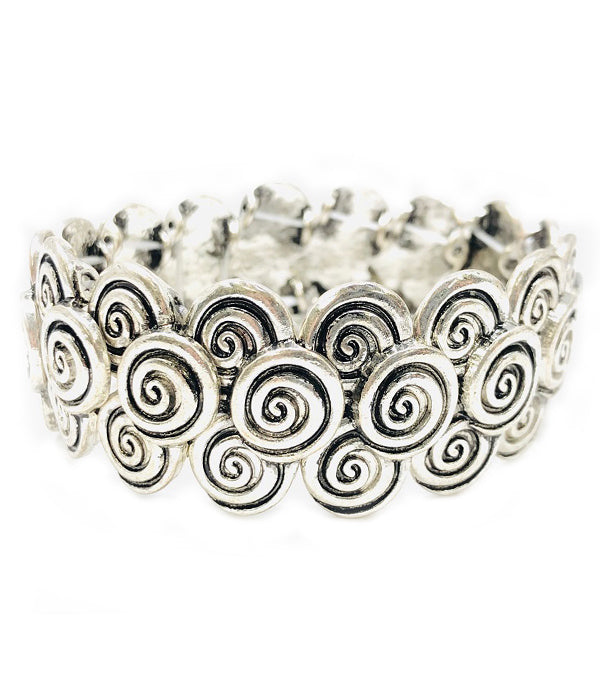 Silver bracelet with spiral design on a white background