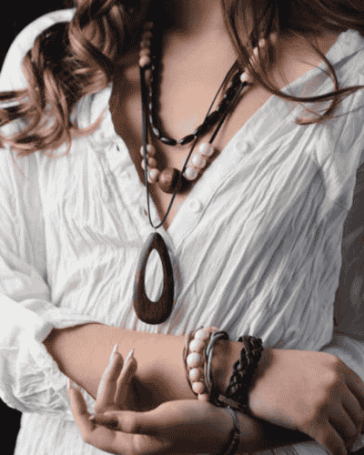 woman in white blouse with boho modern wooden jewelry