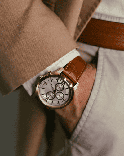 man in suit wearing a luxury leather watch