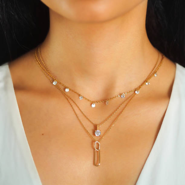 woman wearing boho style layered gold necklaces 
