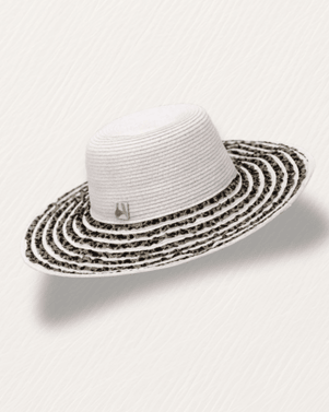 White straw hat with black patterned band on a white background