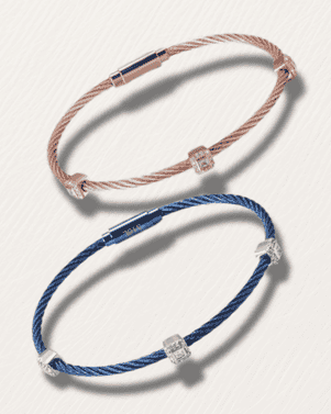 Two bracelets, one blue and one pink, on a light gray background