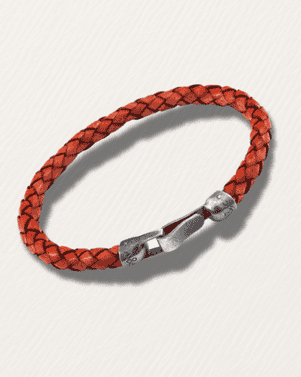 Red braided leather bracelet with a silver clasp on a light gray background