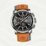 Watch with brown leather strap and black dial on a light gray background