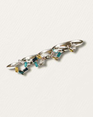 Silver bracelet with colorful gemstones on a light gray background