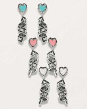 Pair of dangling earrings with heart-shaped charms on a light gray background