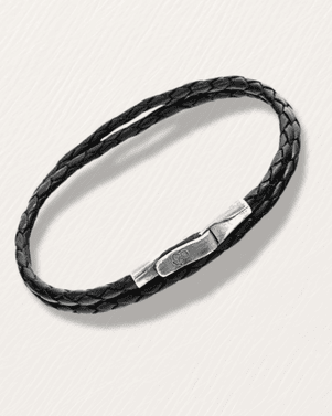Black braided leather bracelet with silver clasp on a light gray background