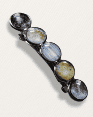 Set of six round ceramic spoons with different patterns on a white background