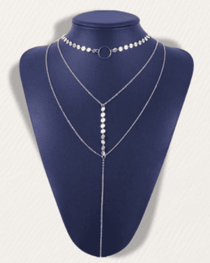 Silver necklace on a blue mannequin bust against a white background