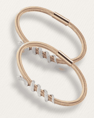 Two rose gold headbands with beaded accents on a light gray background