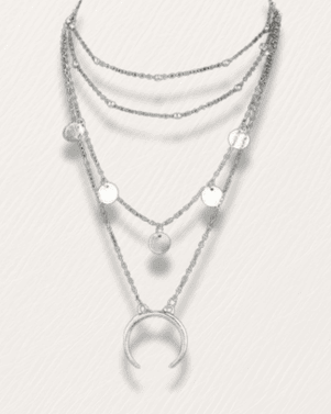 Stack of silver necklaces with various pendants on a white background