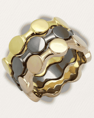 Gold and silver ring with geometric design on a light gray background