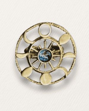 Decorative circular object with gold accents and a central blue gem on a white background