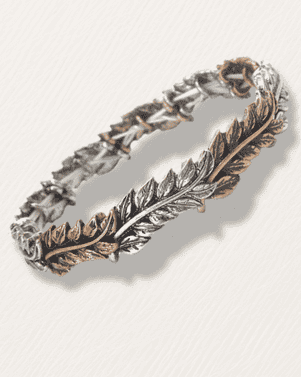 Decorative silver feather-shaped object on a white background