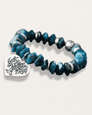 Blue beaded bracelet with a silver tree-shaped charm on a white background