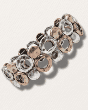 Metallic hair clip with circular design on a white background