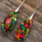 Colorful floral-patterned earrings on a wooden surface