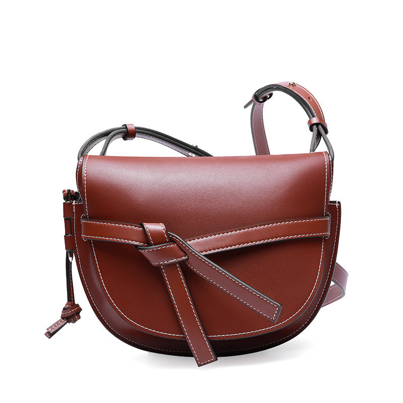 Brown leather handbag on a white background